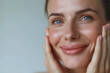 © Oksana_Latysheva - Closeup Beautiful smiling mature woman touch face with smooth healthy skin