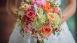 A bride holding a bouquet of colorful flowers including pink, orange, and green