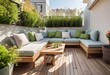 Cozy relaxing area at home back yard. Sunny stylish balcony terrace in the city. Beautiful of modern terrace with wood deck flooring, green potted flowers plants and outdoors furniture. 
