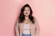 © Анастасия Бутко - Portrait of overweight asian woman against a light pink studio background with copy space