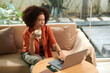 © DragonImages - Businesswoman having morning coffee when answering emails from colleagues and customers