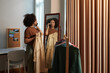 © DragonImages - Smiling Latin woman talking on phone when getting ready on the morning