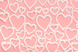 Fototapeta Miasto - sweet meringue kiss cookies of heart shapes over pink background, concept of St. Valentines Day
