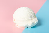 Fototapeta Uliczki - vanilla scoop of sundae ice cream on blue and pink background, close up
