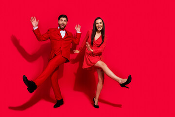 Poster - Full body photo of pretty lady handsome man have fun dancing christmas event isolated on red color background