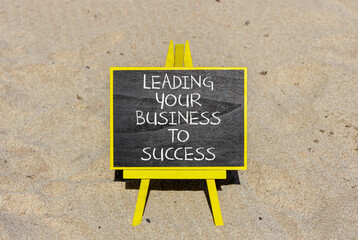 Wall Mural - Leading your business to success symbol. Concept words Leading your business to success on beautiful blackboard. Beautiful sand beach background. Leading your business to success concept. Copy space