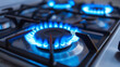 Kitchen stove blue gas burner with gas on. Gas prices, heat and cook with gas