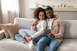 © Prostock-studio - Happy black spouses have video call chatting by tablet indoor