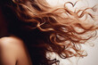 © Bonsales - Thick brown curly well groomed female hair flutters in wind close up. Healthy long hair of young modern brunette woman