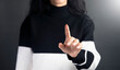 © ARAMYAN - a woman in a black and white sweater pointing at something