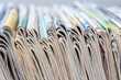 Row of magazine newspapers stacks with blur background