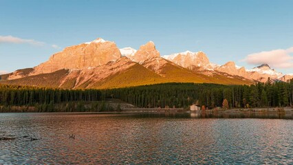 Wall Mural - Sunrise on Mount Rundle with blue sky on Rundle Forebay reservoir in autumn at Canmore, Canada