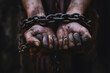 Close-up of hands tied with chains, depicting the concept of human trafficking and captivity.