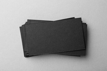 Wall Mural - Blank black business cards on light background, top view. Mockup for design