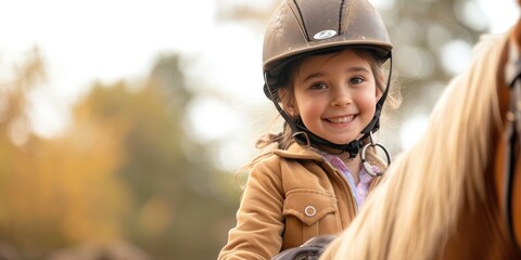 Equitation lesson. Happy child girl while riding a horse