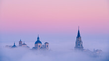 Foggy Sunrise Over Historical Buildings