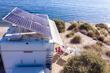 Wall Mural - Caravan with tilt solar panels on roof. Aerial view.