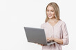 © InsideCreativeHouse - Young happy smiling woman in casual clothes holding laptop and sending email . Caucasian smiley freelancer office worker influencer ceo with computer working remotely