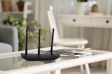 Poster - Modern wi-fi router and magazines on table in living room, closeup