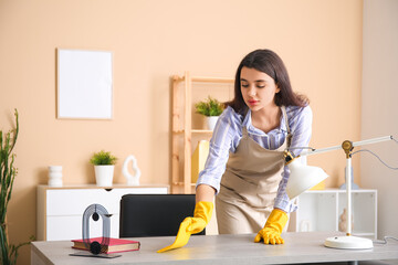 Wall Mural - Young woman cleaning desk in living room