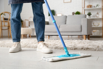 Poster - Woman mopping floor in living room