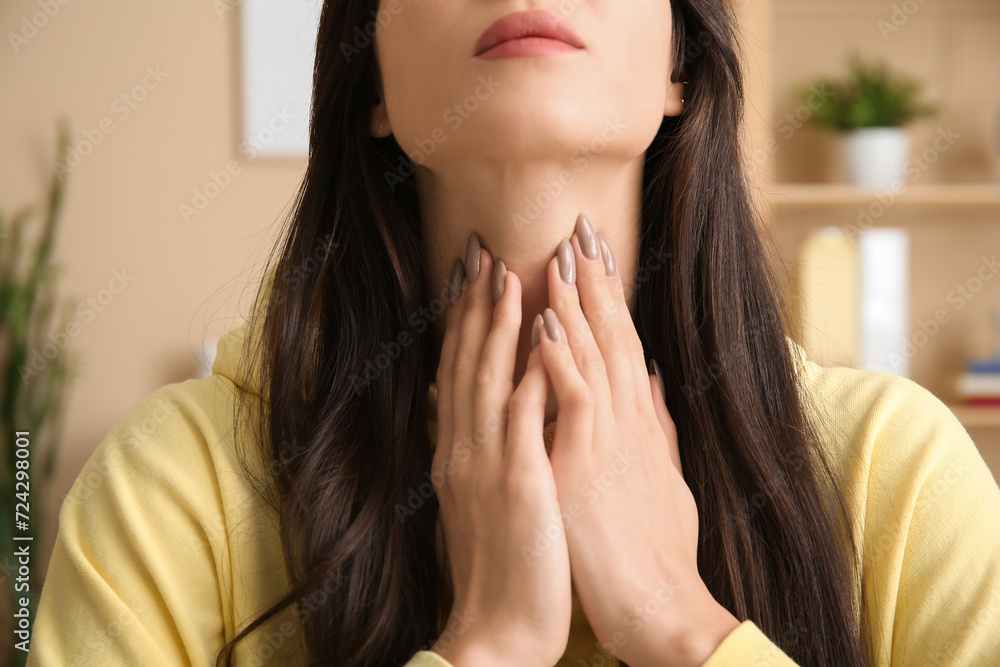 Young woman with thyroid gland problem at home, closeup