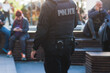 Police squad formation on duty maintain public order in the european city streets, group of policemen patrol  in body armor with 