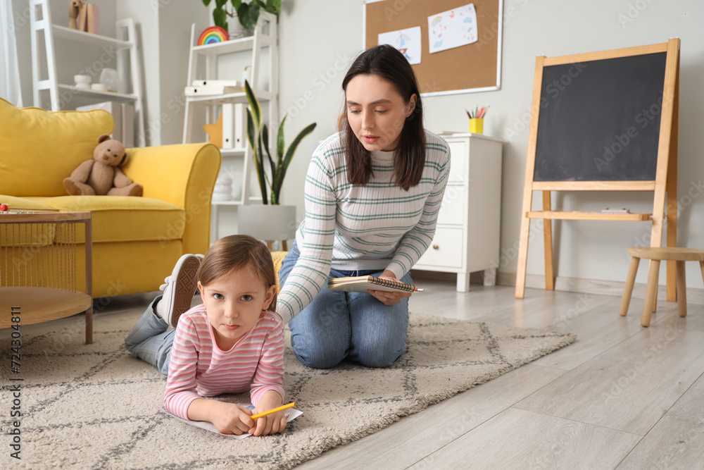 Sad little girl drawing at psychologist's office