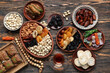 Composition with traditional Eastern sweets, tea and tasbih for Ramadan on wooden background