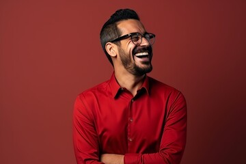 Poster - Handsome young man wearing a red shirt and glasses laughing while standing against a red background