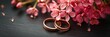 wedding rings with flowers on solid background