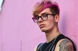 Portrait of a handsome young hipster man with pink hair and glasses