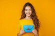 Happy cheerful smiling beautiful young woman standing and holding blue envelope.