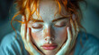 Young woman with freckles and red hair holds his head during headaches and stress
