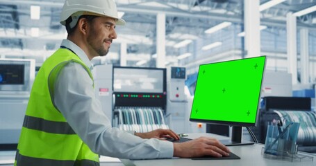Aufkleber - Caucasian Male Industrial Engineer In Protective Gear Working on a Desktop Computer with Green Screen Chromakey on Display at an Electronics Factory. Technological Research and Development Center.