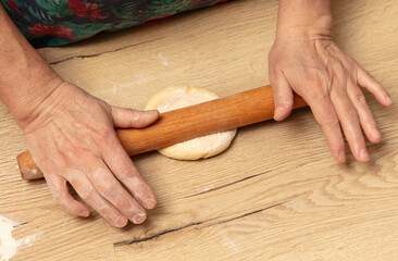 Sticker - A woman rolls out dough with a rolling pin