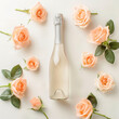 A bottle of sparking of champagne in flowers, on a style of light peach background in pastel colors. Top view with a light meta for text. Advertising photo

