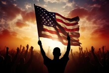 A Powerful Image Of A Man Holding The American Flag In Front Of A Stunning Sunset, Silhouette Of Arms Raised Waving A USA Flag With Pride, AI Generated
