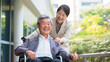 シニアと介護、車椅子に乗る日本人男性と介護士の女性
