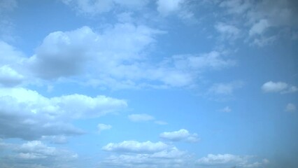 Wall Mural - Slow moving white clouds in a blue summer sky. Soothing unhurried background as a substrate for titles.