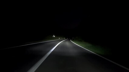 Wall Mural - driving a car on countryside road at night with adaptive matrix headlights