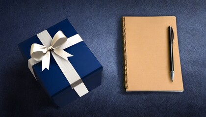 Canvas Print - blue gift box and notebook on dark blue background greeting card for businessmen