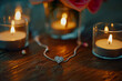 © mihrzn - An elegant necklace with a heart-shaped pendant sparkling under soft candlelight.