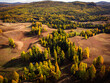 Aerial shot of the Altai landscape during fall, showcasing the vivid autumn colors and rolling hills.