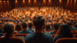 © mattegg - Group of People Sitting in Front of an Auditorium