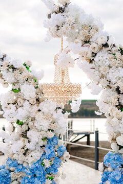 Close up of wedding decorated arch with white and blue flowers
