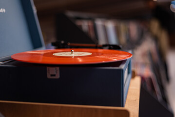 A vinyl record player on the background of a music store window. Vintage vinyl record player.