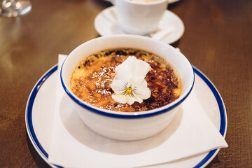 Traditional French pastry Crème brûlée is a smooth and creamy custard topped with crisp, caramelized sugar