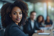 © Marcos - A stylish afro American businesswoman during working meeting in office. Female entrepreneurship businesswoman, empowered, self-confident, confident, leader concept