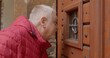 © Alena - Human Curiosity: An Insight into Human Behavior. Curious Elderly Man Peering through Small Window of Closed Door. Spirit of curiosity and simple yet profound moments of exploration in everyday life.